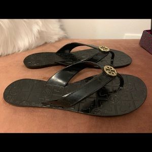 Tory Burch black thong sandal with gold tone logo